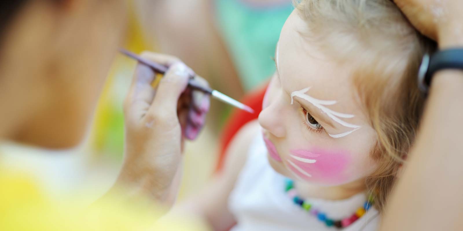 Little girl during a make-up workshop at the children's club at Le Bois Tordu 85 campsite