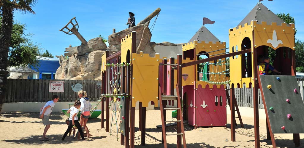 Turnstile and climbing structure on the campsite playground in Vendée le Bois Tordu