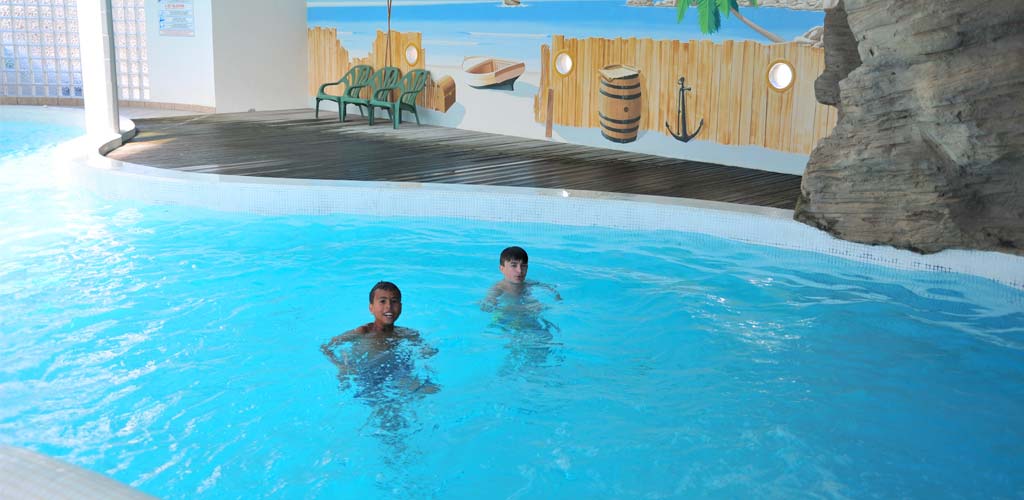 Enfants dans la piscine couverte du camping à Saint-Hilaire en Vendée
